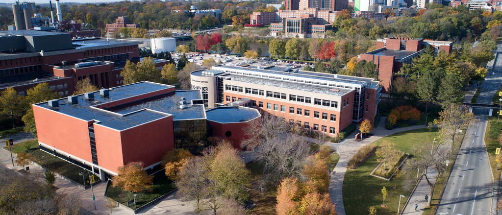 An aerial photograph with the Becker Communication Studies Building in the foreground