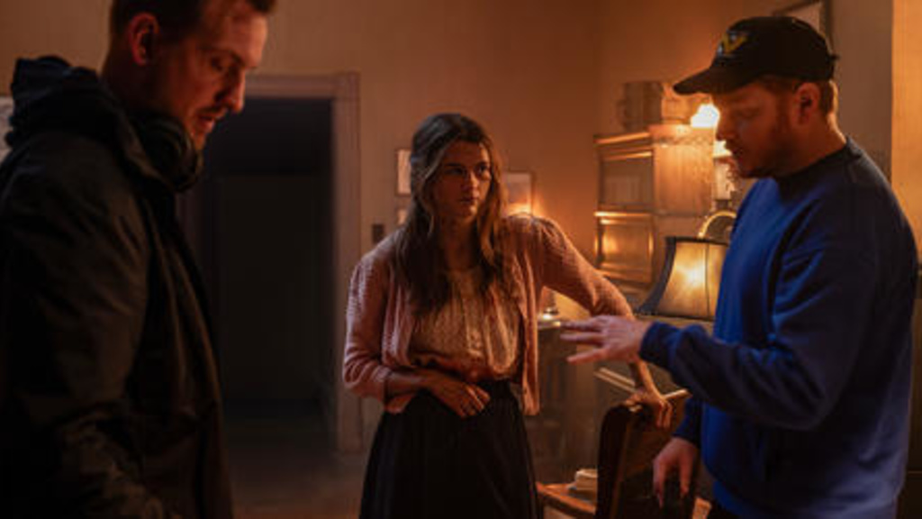 Scott Beck, Chloe East, and Bryan Woods working on the set of the film Heretic.